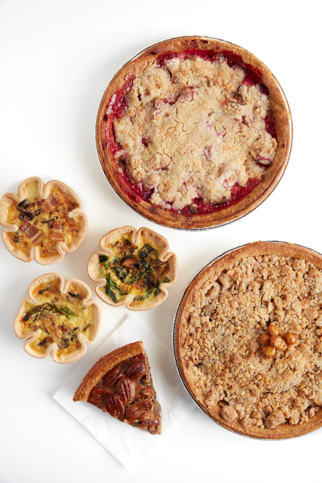 Birds eye view of a selection of Starter Bakery pies and quiches filled with seasonal fruit and vegetables